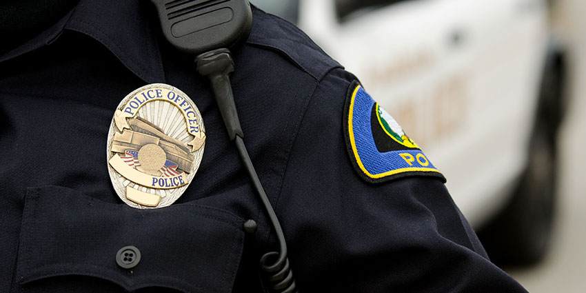 Close-up of police officer uniform and badge