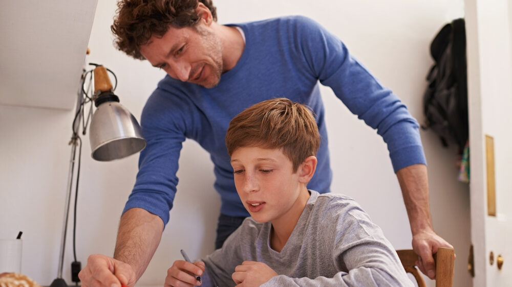 A mentor help young child in studies