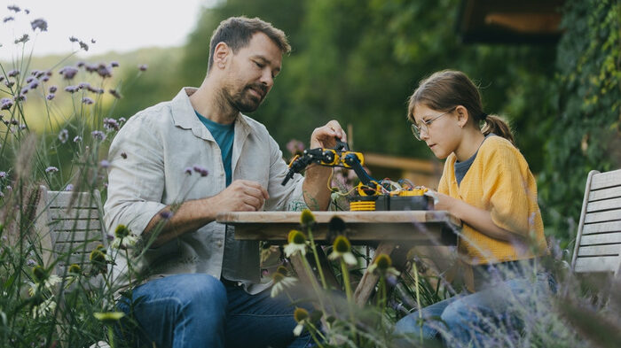 A mentor helping mentee in learning new skills